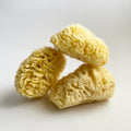 All-natural sea sponge trio, light yellow sponge pieces with natural pores.