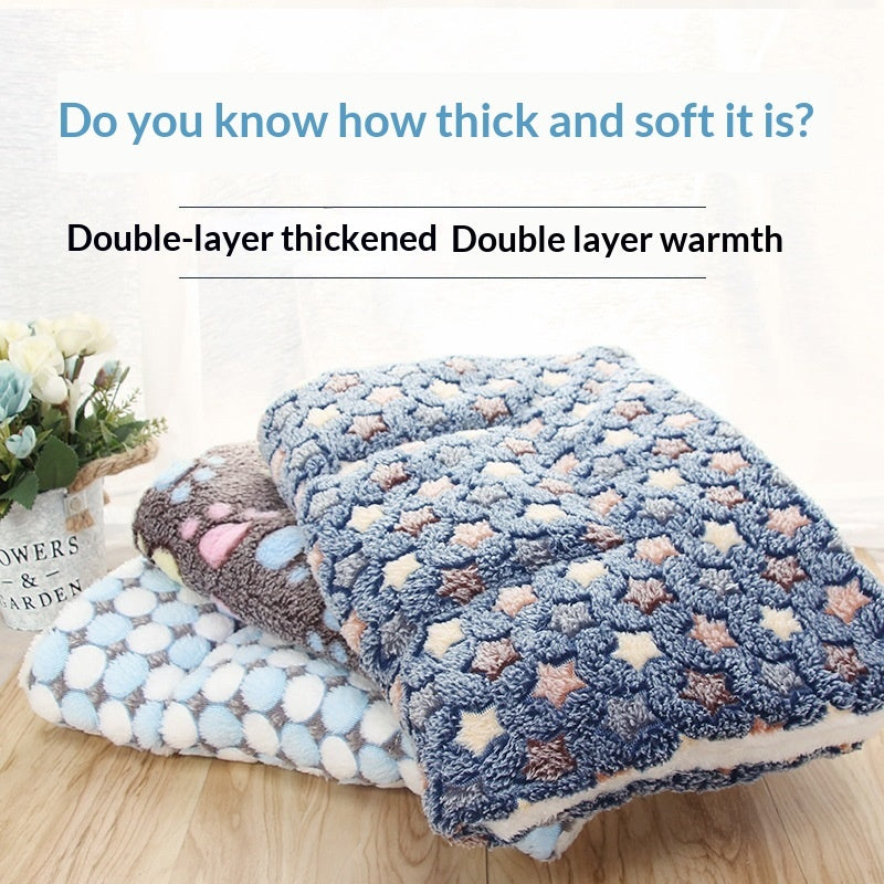 Blue paw-and-star patterned pet mat with plush sherpa lining