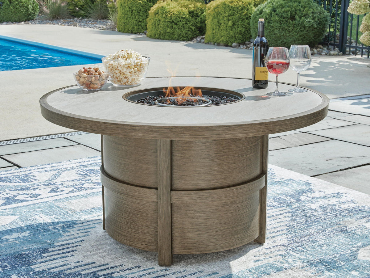 Round fire pit table with burning burner in beige tabletop and wood base