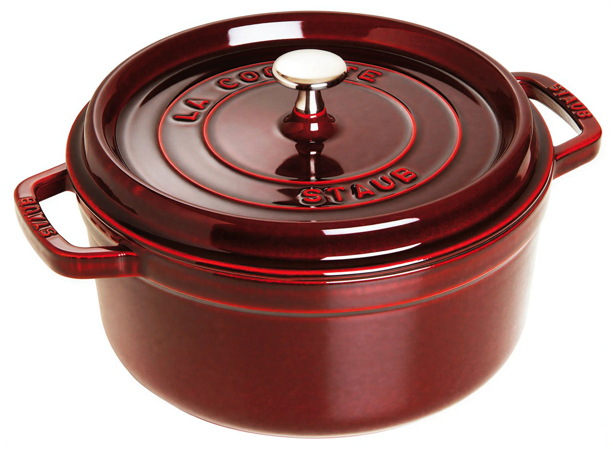Staub enameled cast iron Dutch oven with red lid, stainless knob and side handles