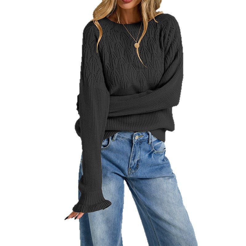 Black womens crew-neck sweater with textured knit and long sleeves, worn with jeans