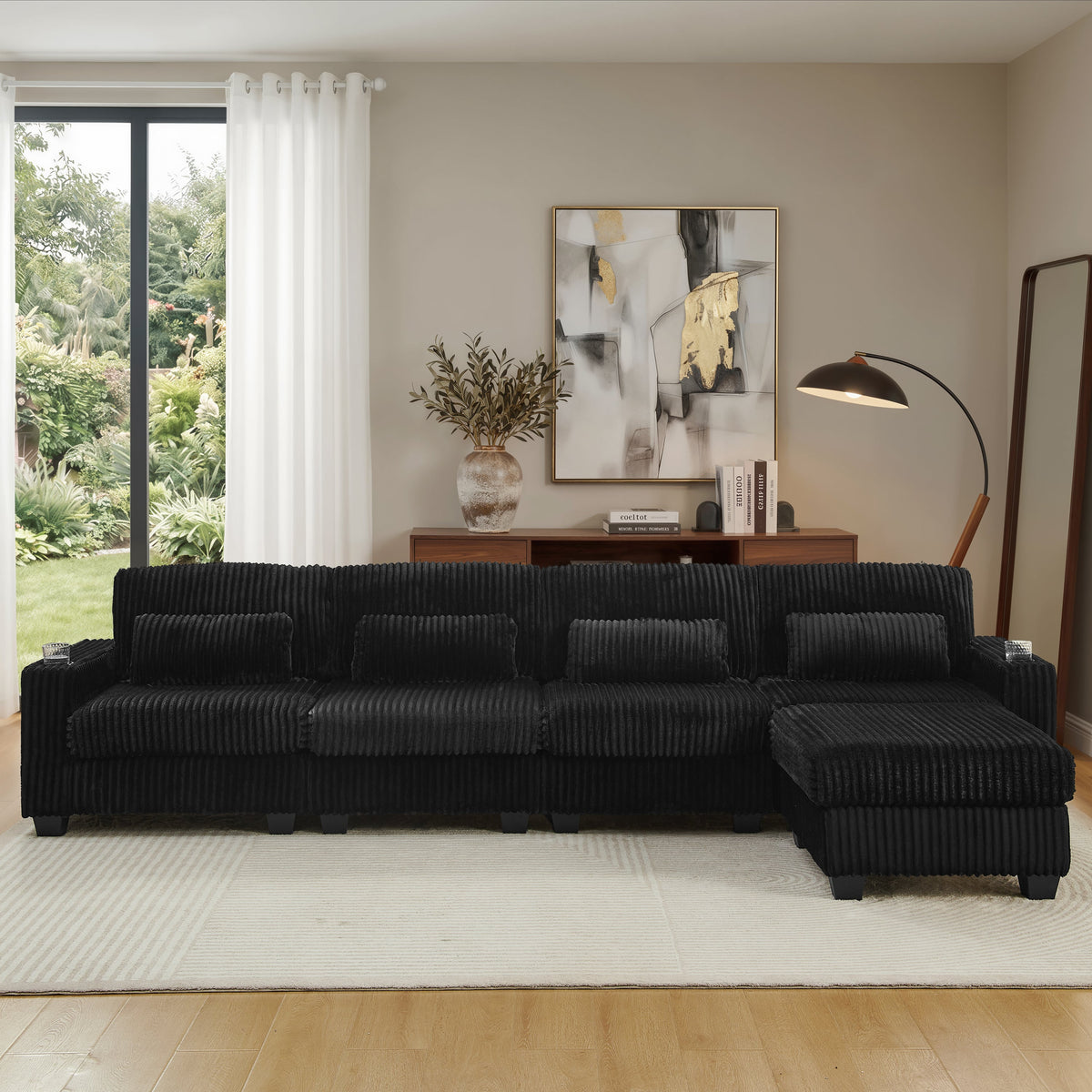 Black corduroy sectional sofa with chaise and wide back cushions, front view