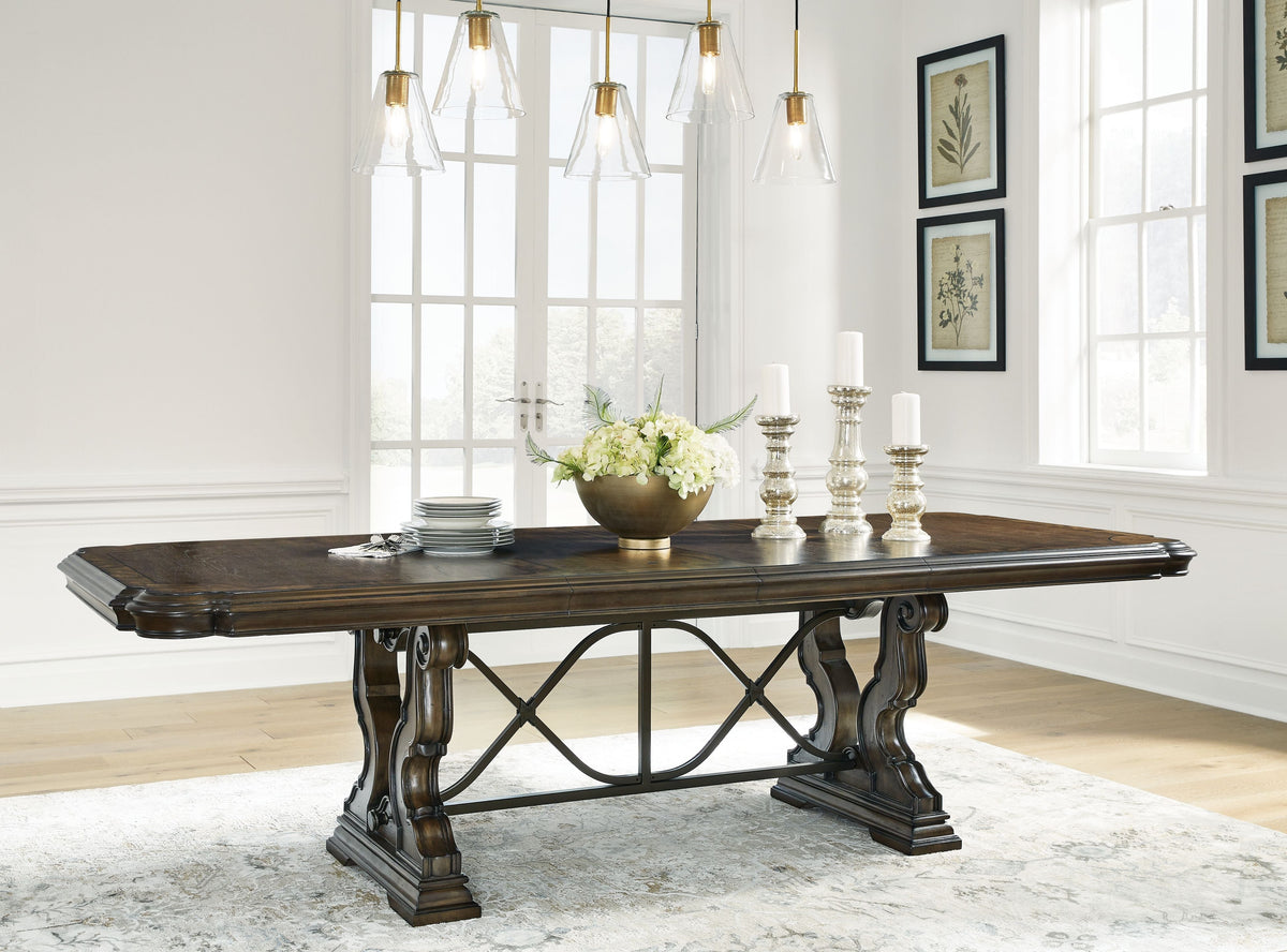 Dark brown dining extension table with X-base and carved, turned legs