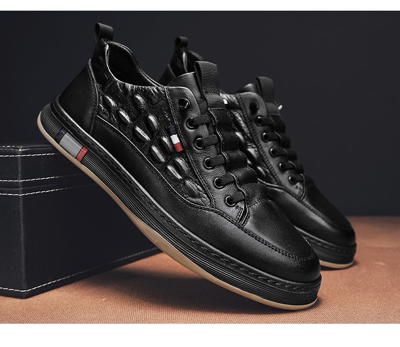 Black leather-look lace-up sneakers with textured panels and contrast stripe detail.