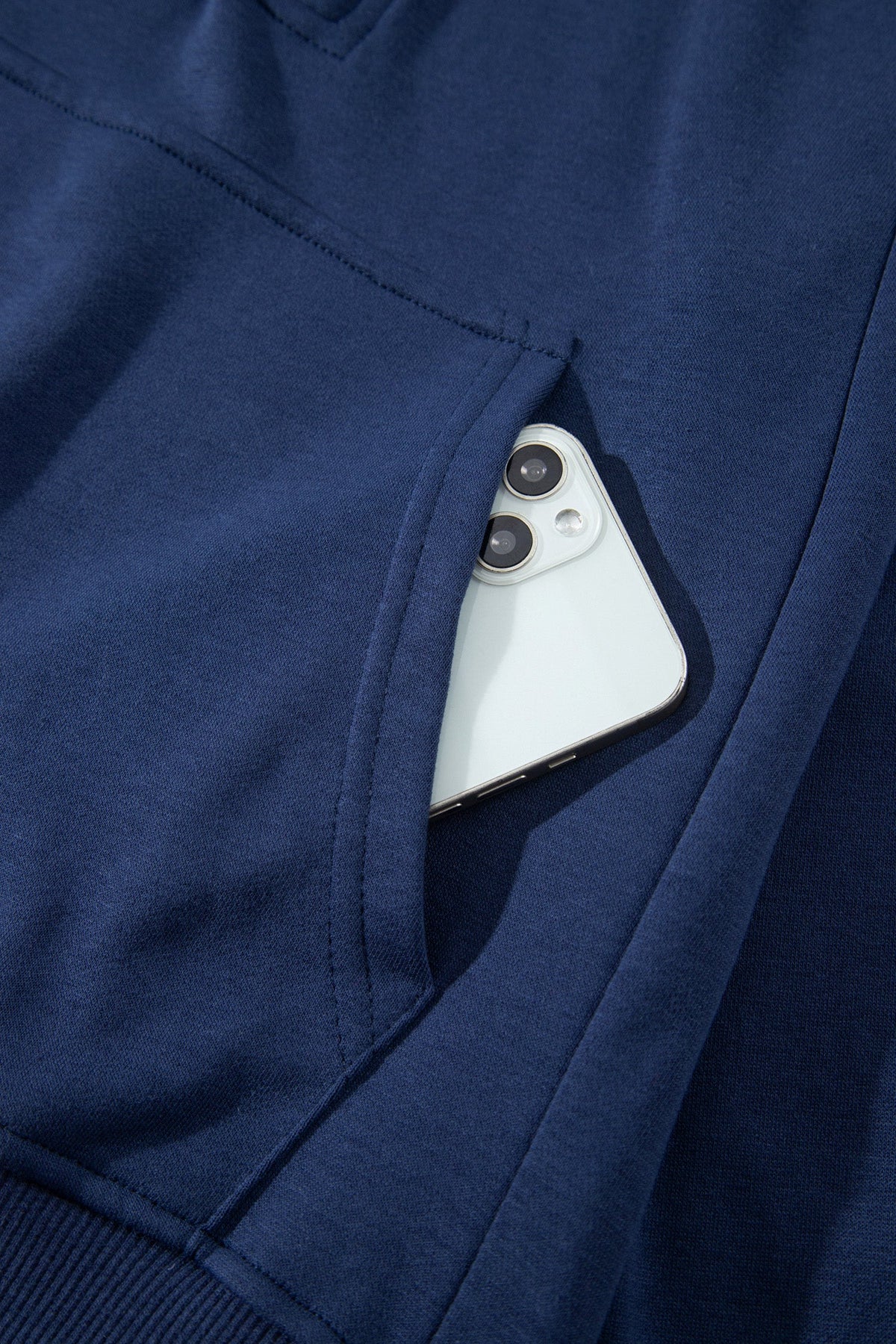 Navy zip-up long-sleeve top with kangaroo pocket, close-up