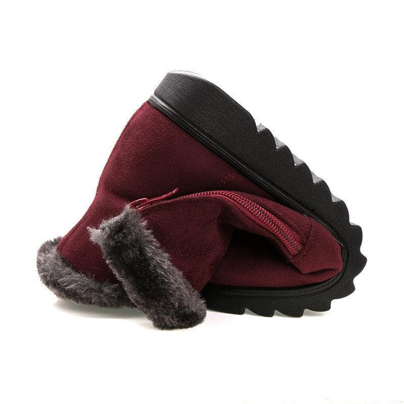 Women’s burgundy winter ankle boots with faux-fur cuff and thick platform tread sole.