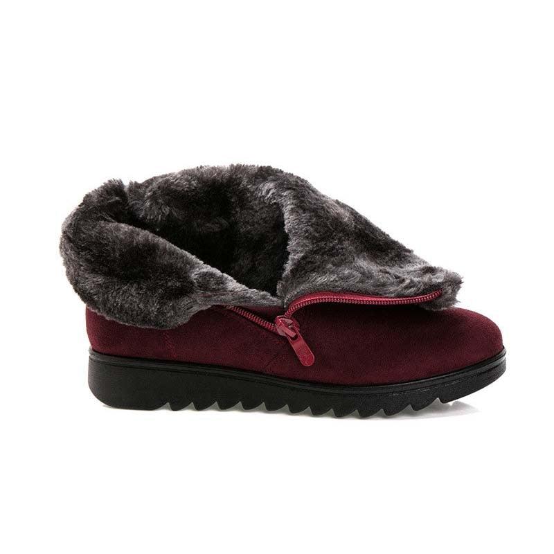 Women’s burgundy winter slip-on style boots with faux-fur trim and ridged tread sole.