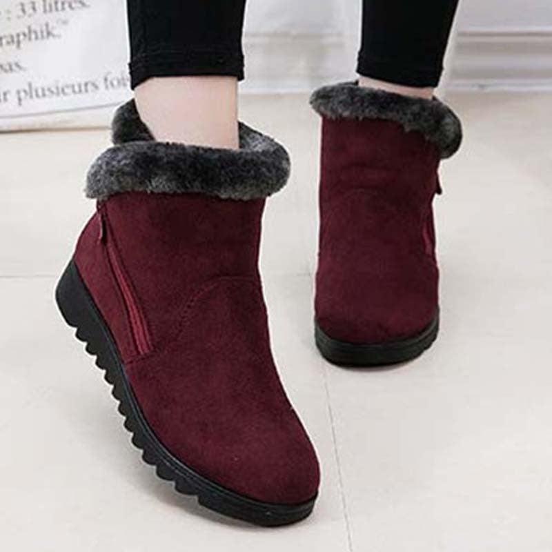 Women’s burgundy winter mid-calf boots with faux-fur trim, side zipper, and grippy tread sole.
