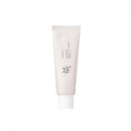 White SPF sunscreen squeeze tube with ridged cap and printed label
