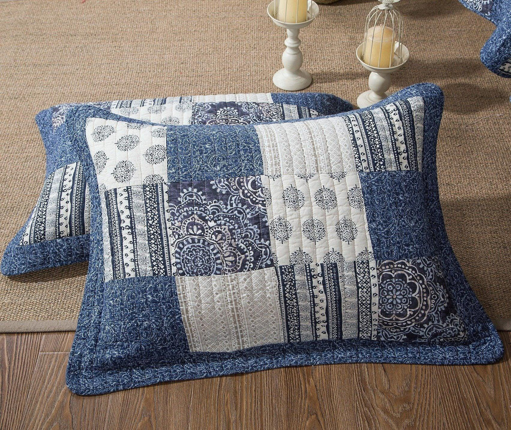 Patchwork cotton quilt set with denim blue and white pillow shams on sofa
