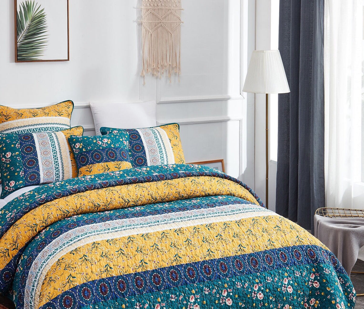 Patchwork quilt set showing teal, yellow, and blue stripe bands on bed