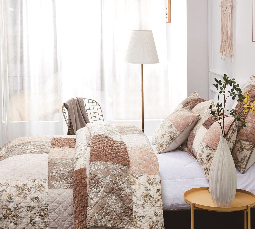 Patchwork quilted bedspread with floral blocks and brown square accent