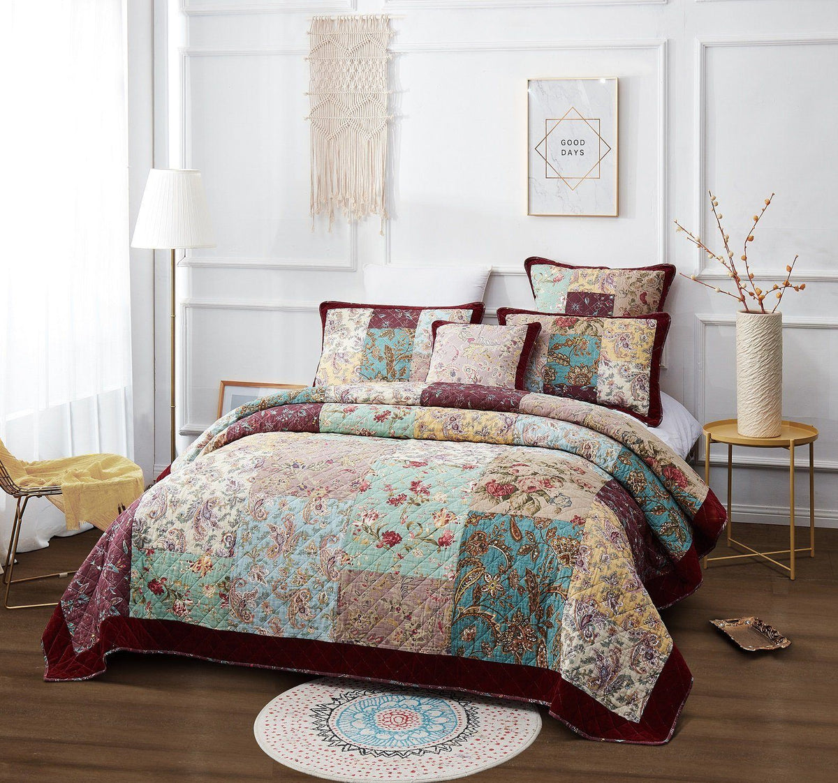 Coordinated quilt set with multicolor paisley patchwork and burgundy trim