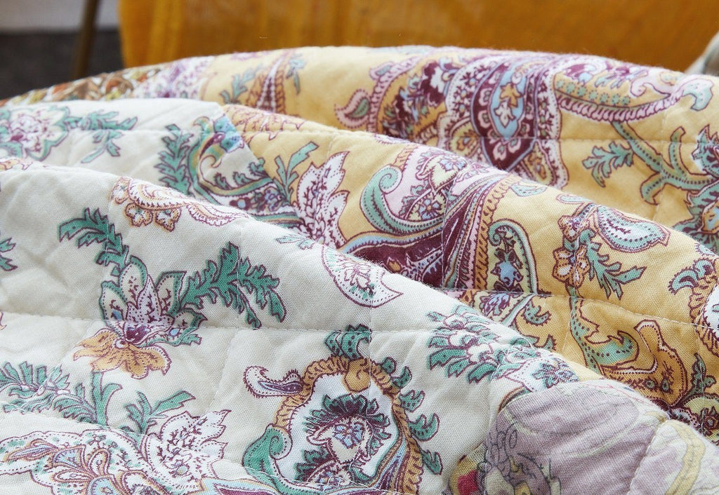 Paisley patchwork quilt cover with floral motifs in teal, cream, and burgundy