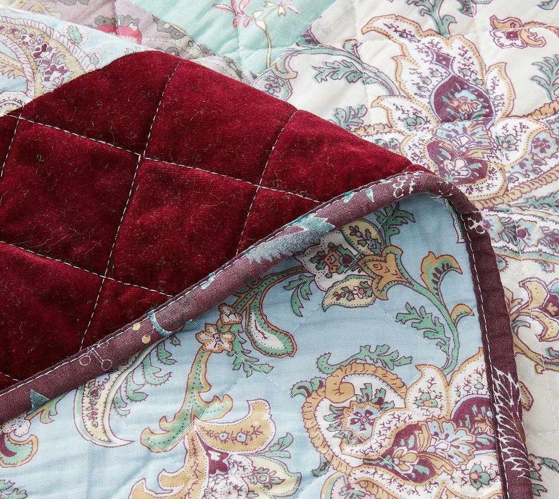 Quilt corner detail with burgundy velvety border and paisley patchwork reverse
