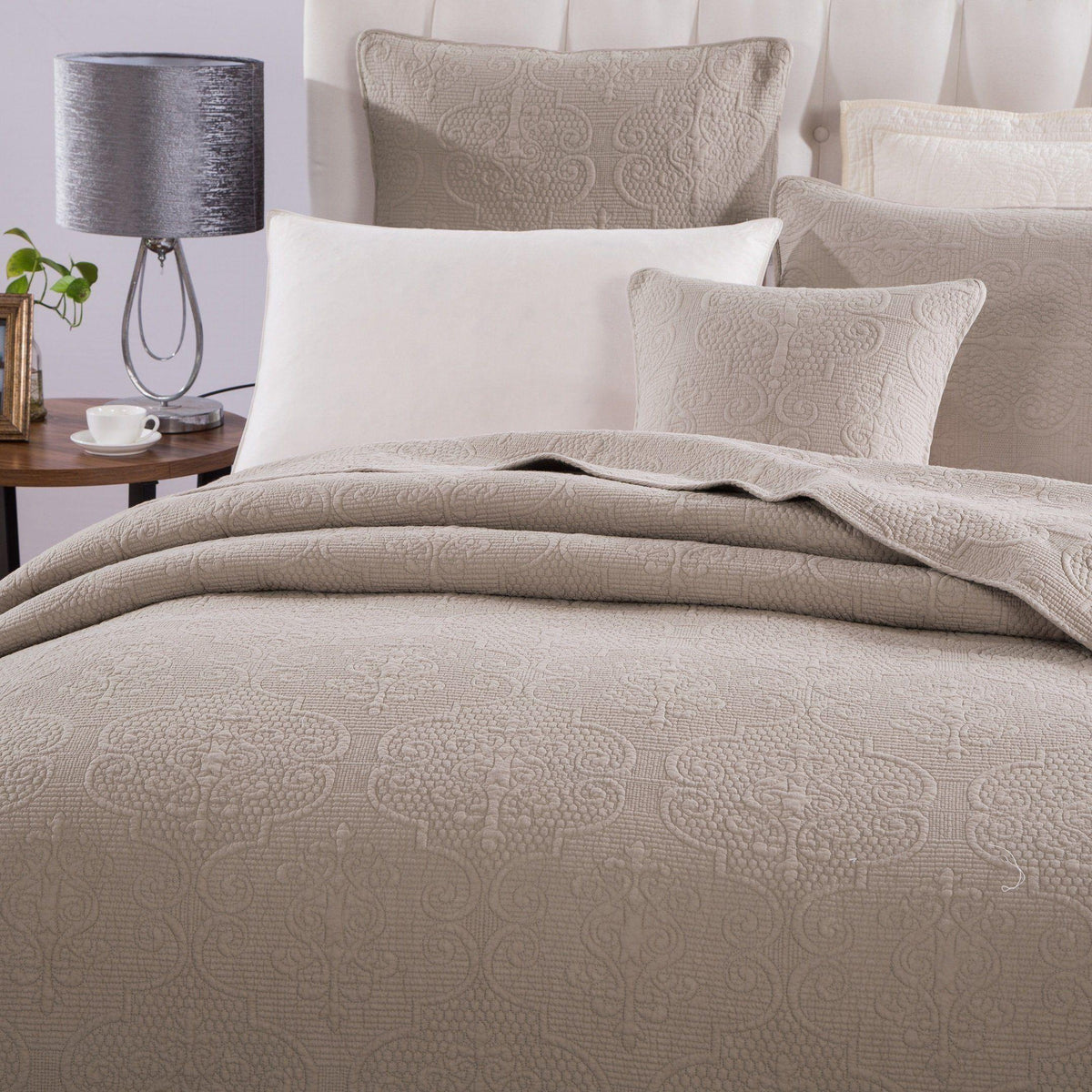 Quilted cotton bedspread with taupe swirl pattern and matching pillow set