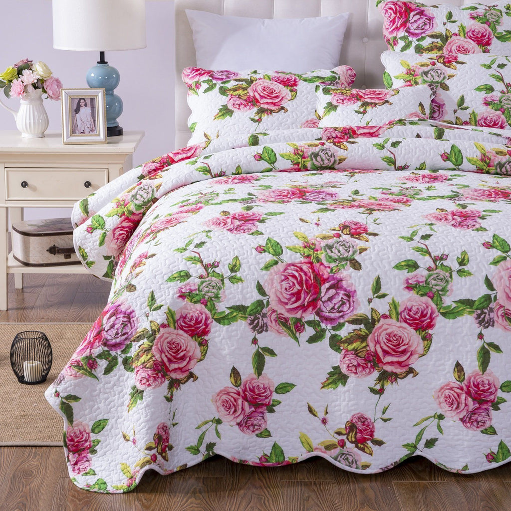 Quilt set with pink roses and green leaves on white background, quilted bedspread