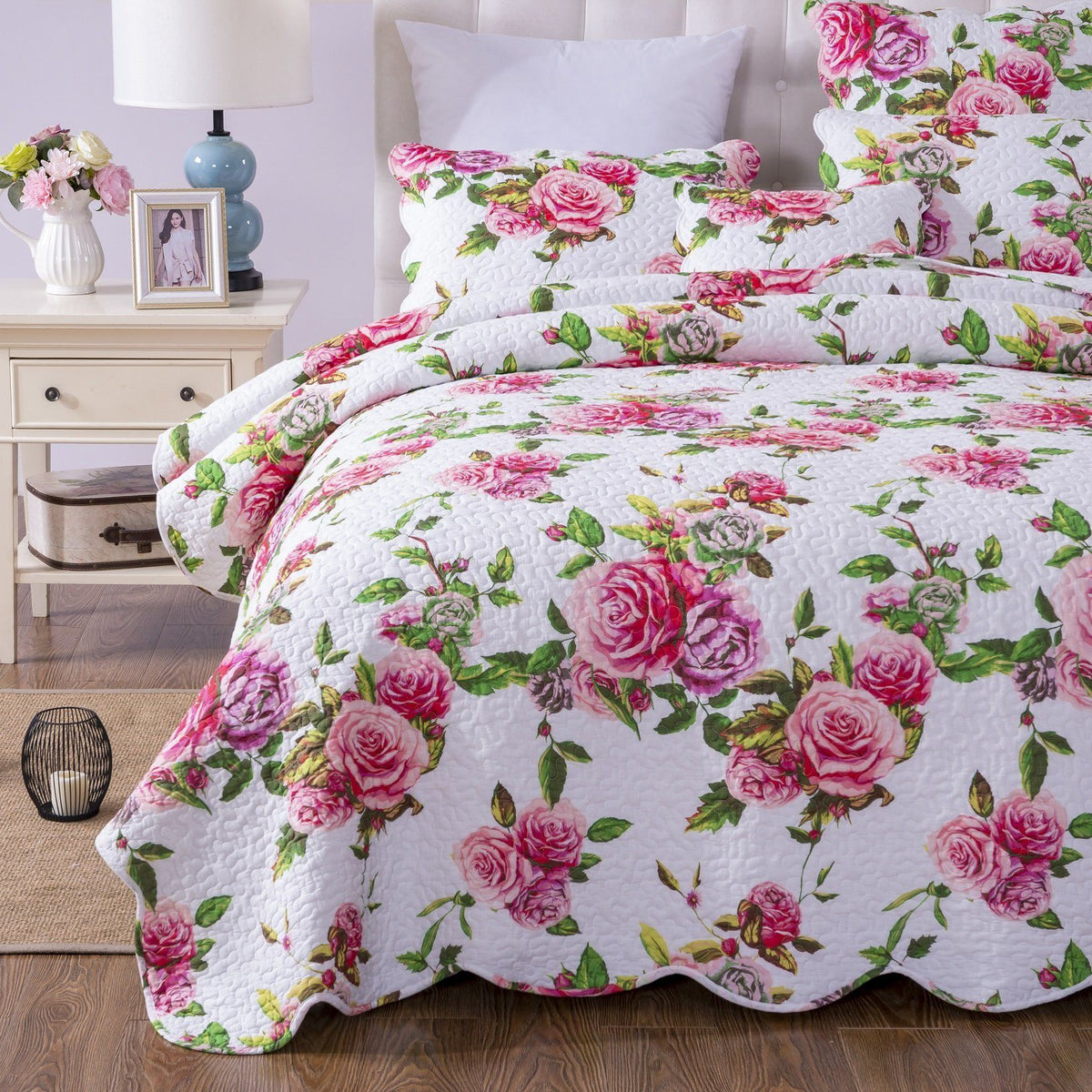 Quilt set with pink roses and green leaves on white background, quilted bedspread