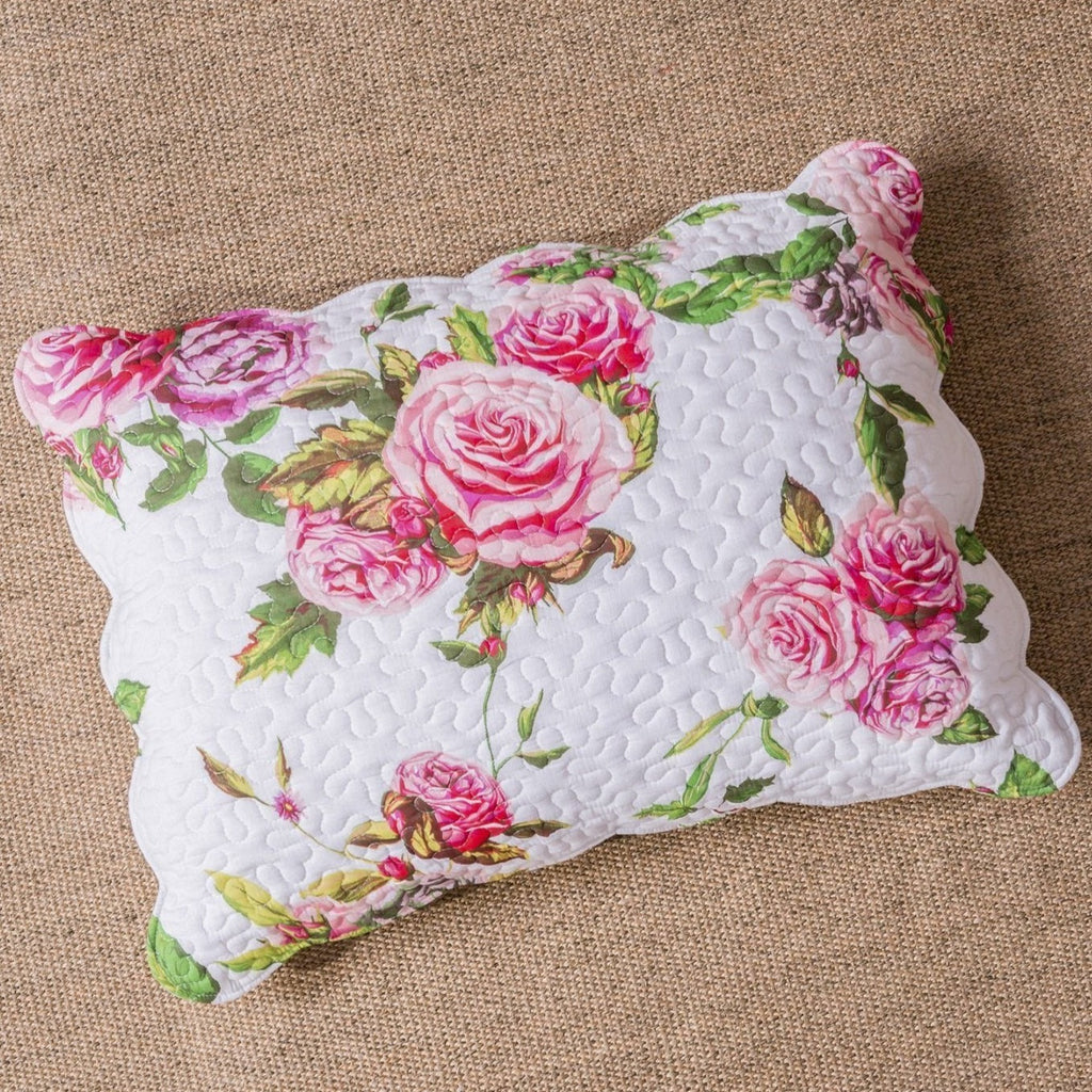 Quilted rectangular pillow sham with pink rose floral print on white fabric