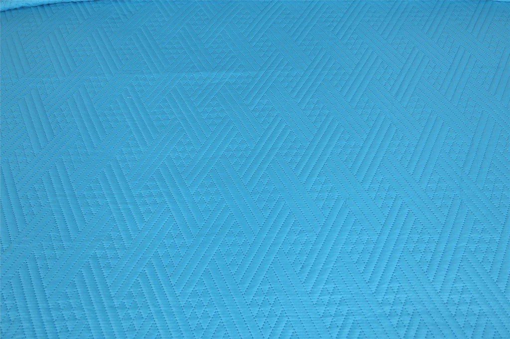 Turquoise teal quilted bedspread fabric with repeating wave stitch pattern