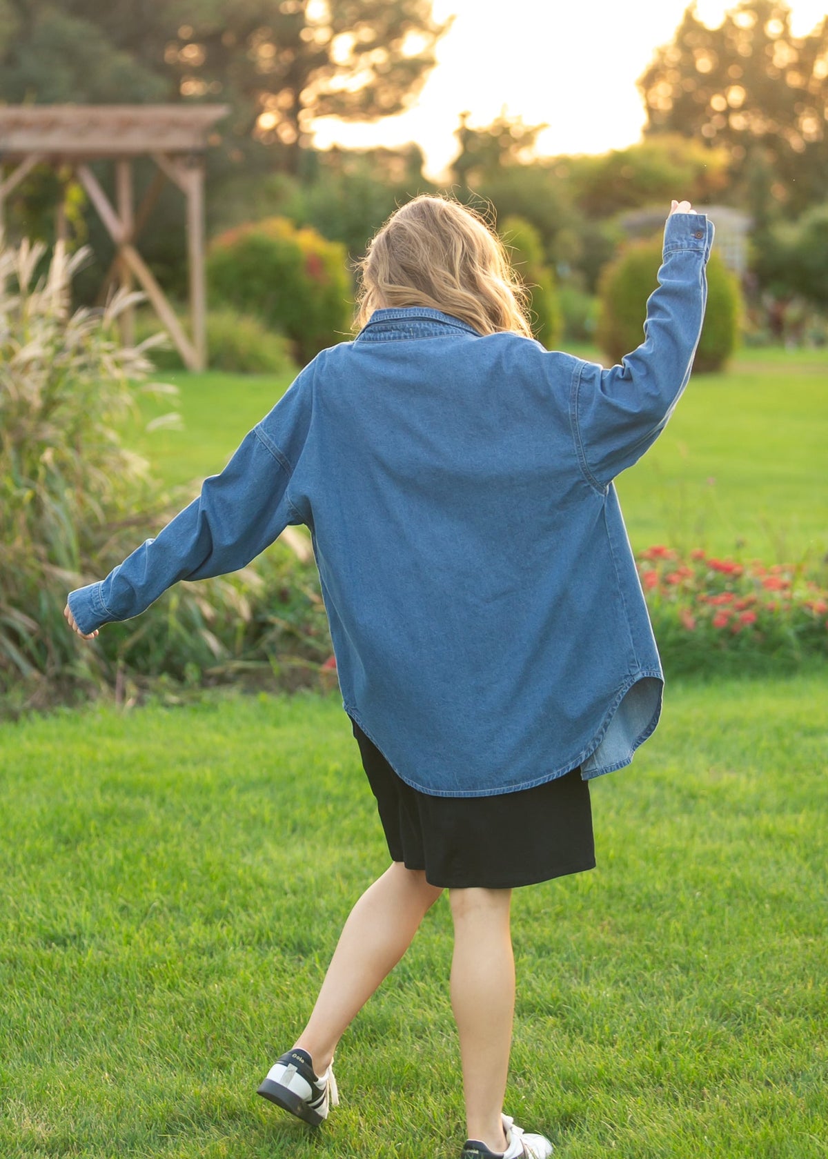 Denim button-up top in medium blue, back view with button front and long sleeves.