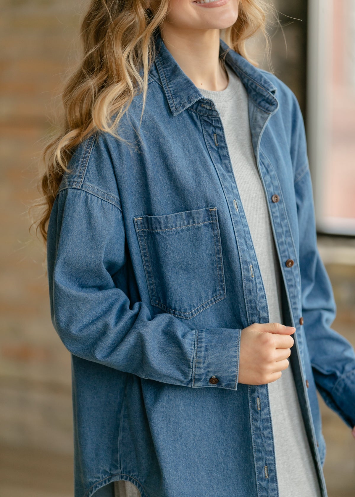 Blue denim button-up top with chest pocket and button placket, long sleeves
