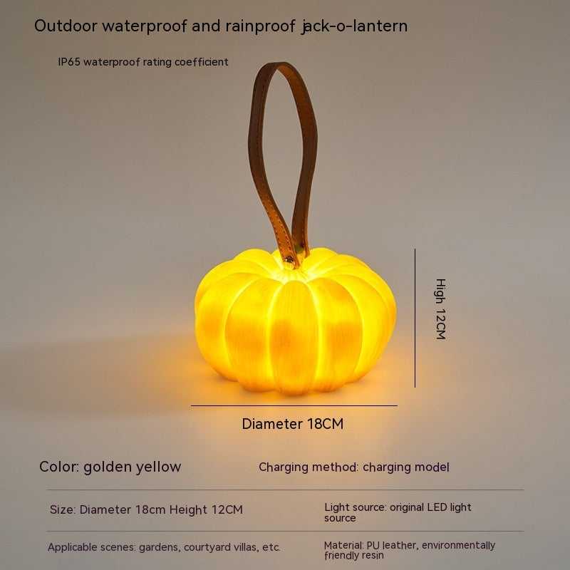 Golden yellow pumpkin-shaped outdoor LED light with hanging loop, size shown