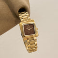 Square quartz watch with gold steel band and dark brown dial