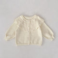 Cream baby knitted coat with textured ruffled lapel and button-front
