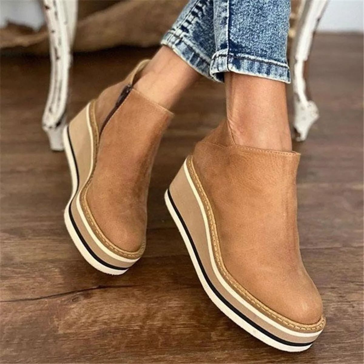 Tan ankle wedge boots with side zipper and striped outsole