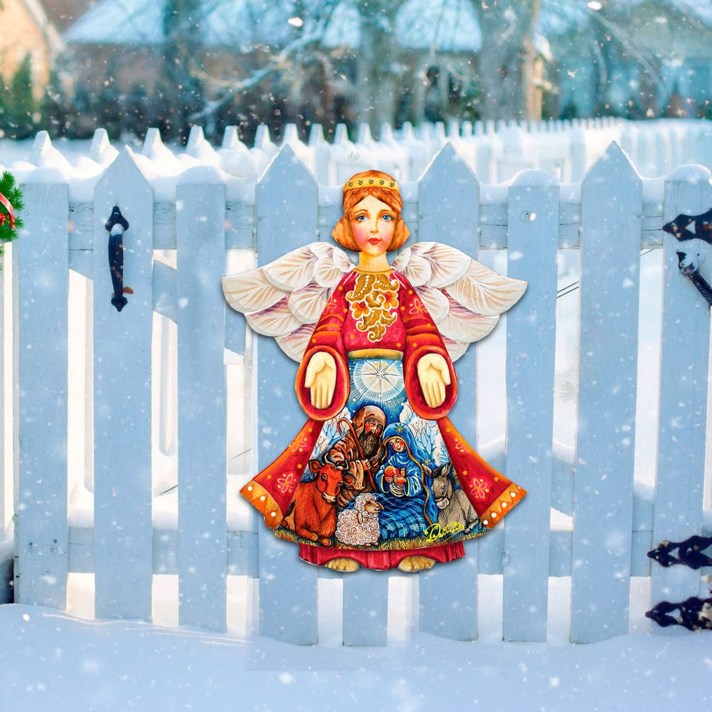 Nativity angel door decor with white wings and red robe over nativity scene, ring handles