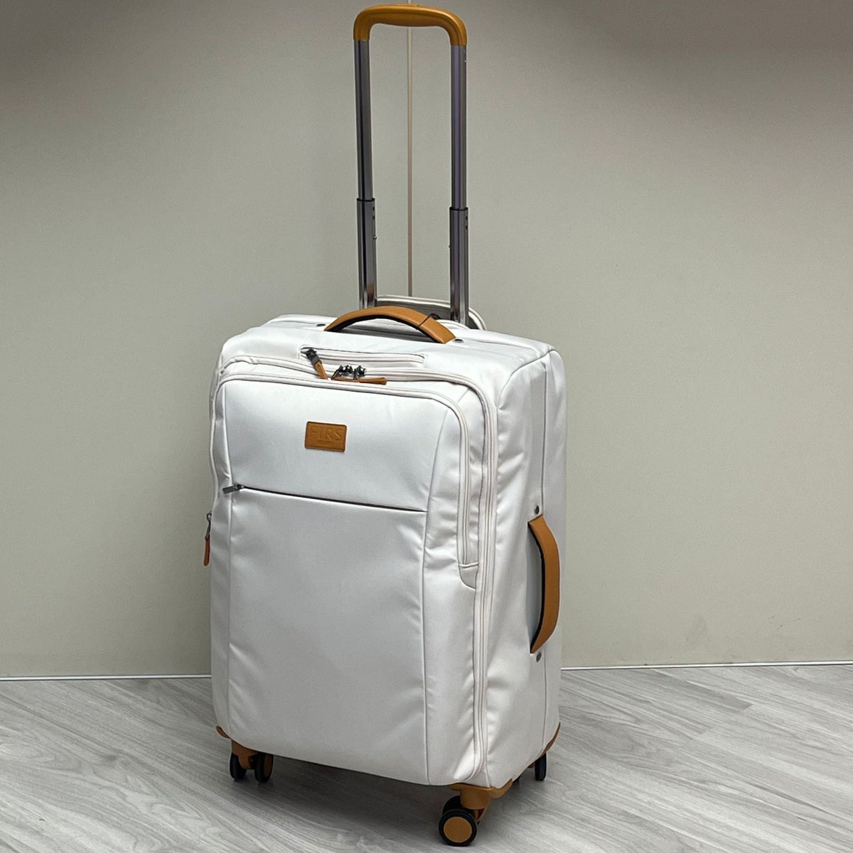 Ultra-light white wheeled trolley suitcase with telescoping handle, orange trim, front pocket