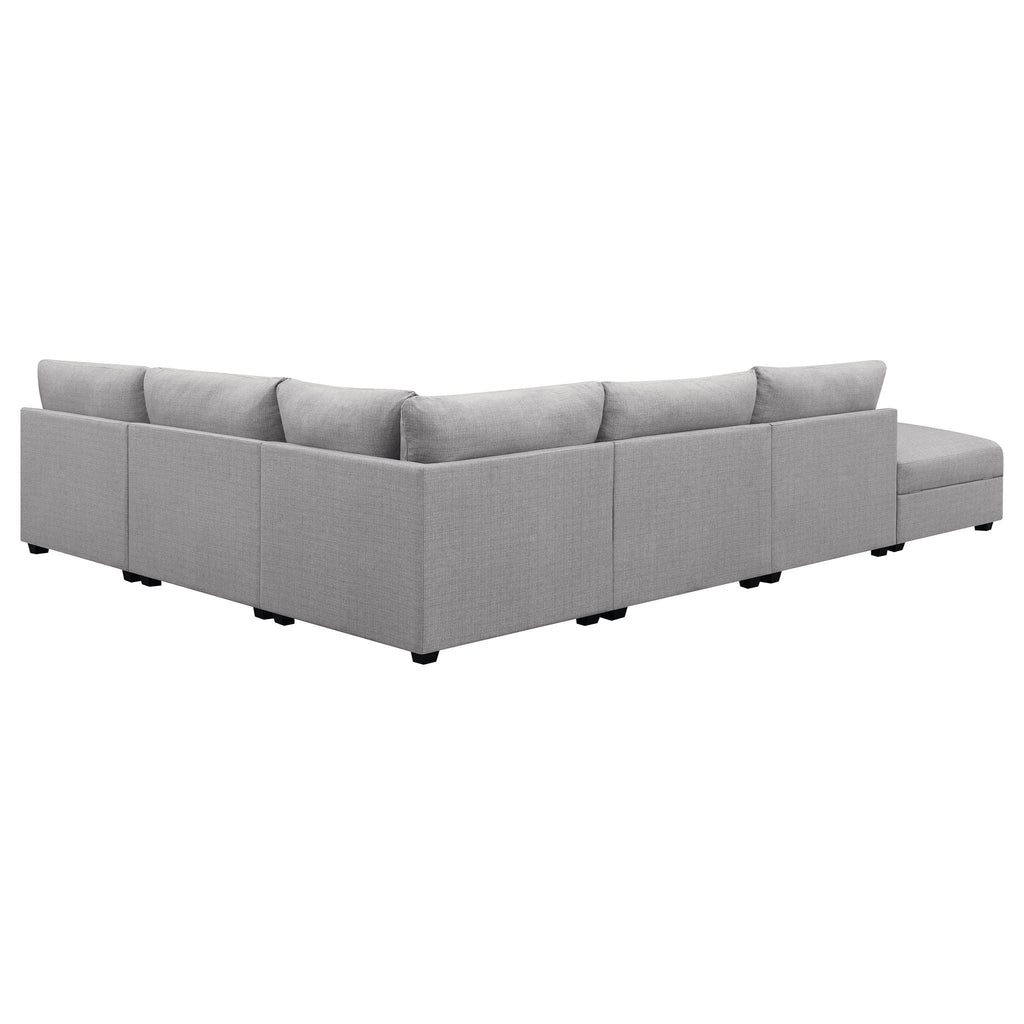 Grey modular sectional sofa with back cushions and block arms, corner view