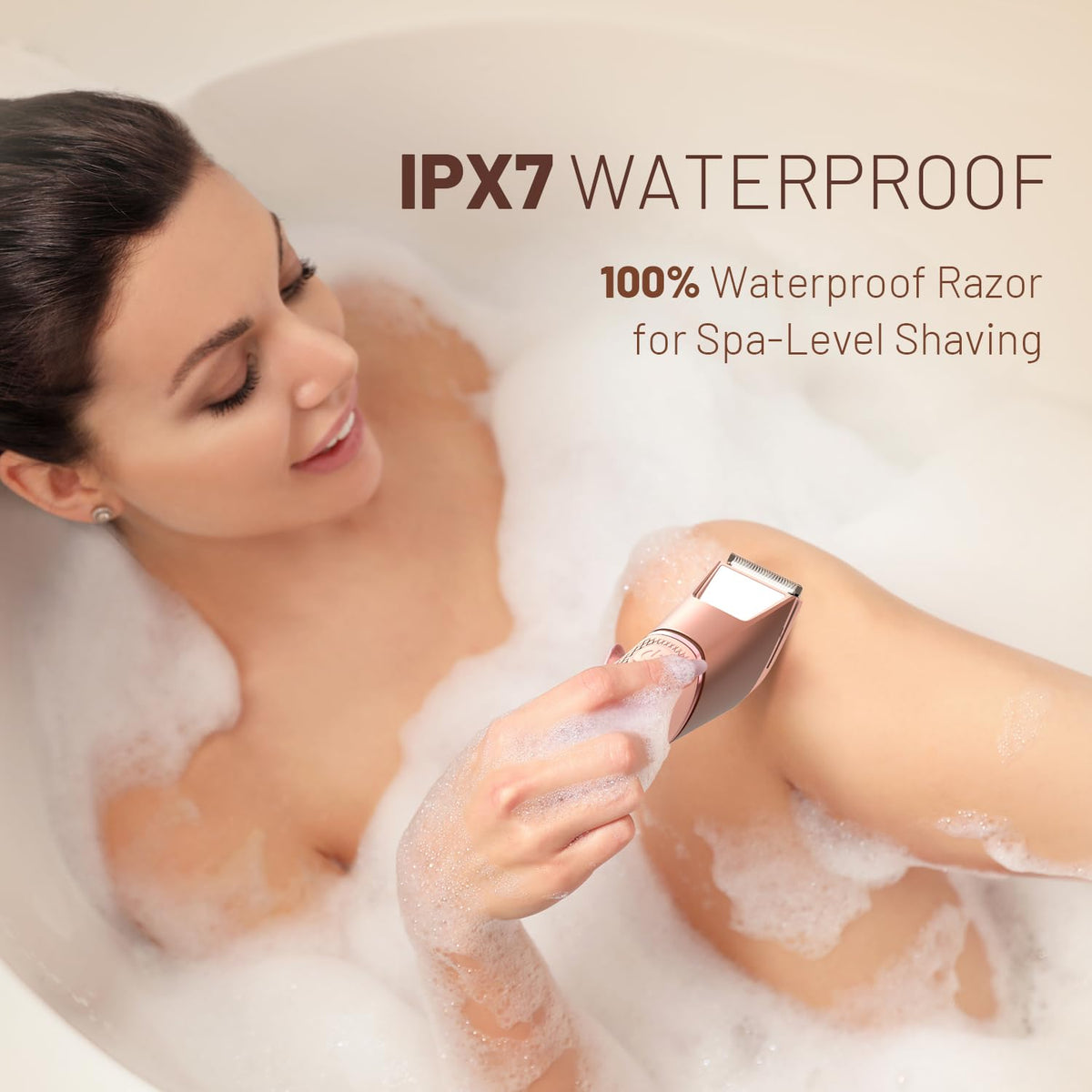 Pink waterproof electric shaver with shaving head used on skin in foam