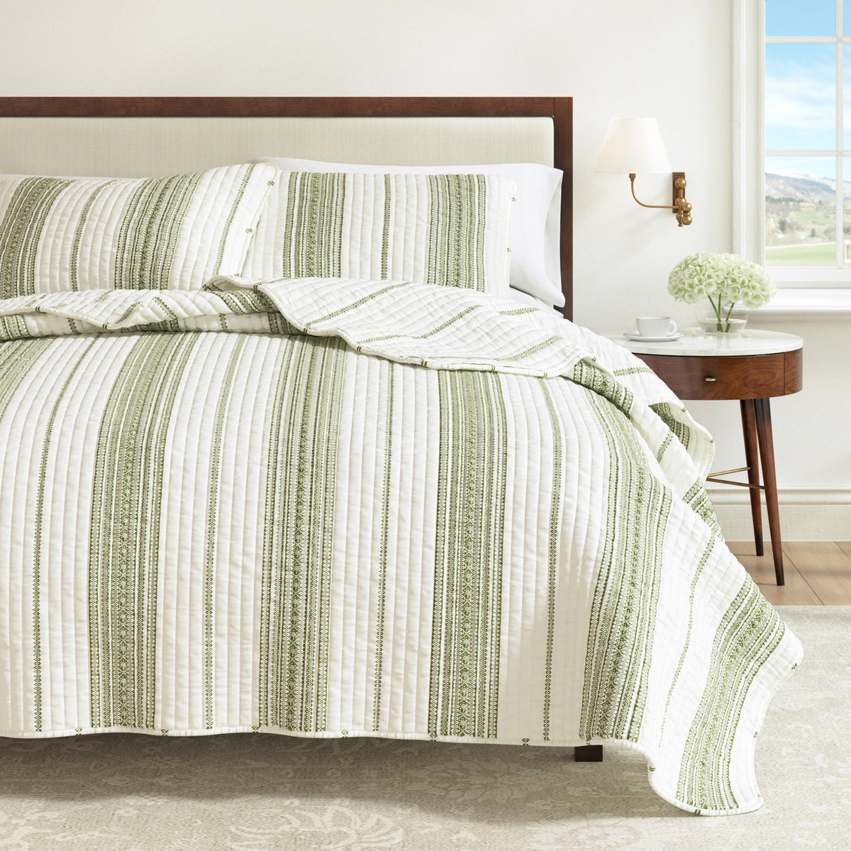 Cream and green striped quilt bedding with matching striped pillows