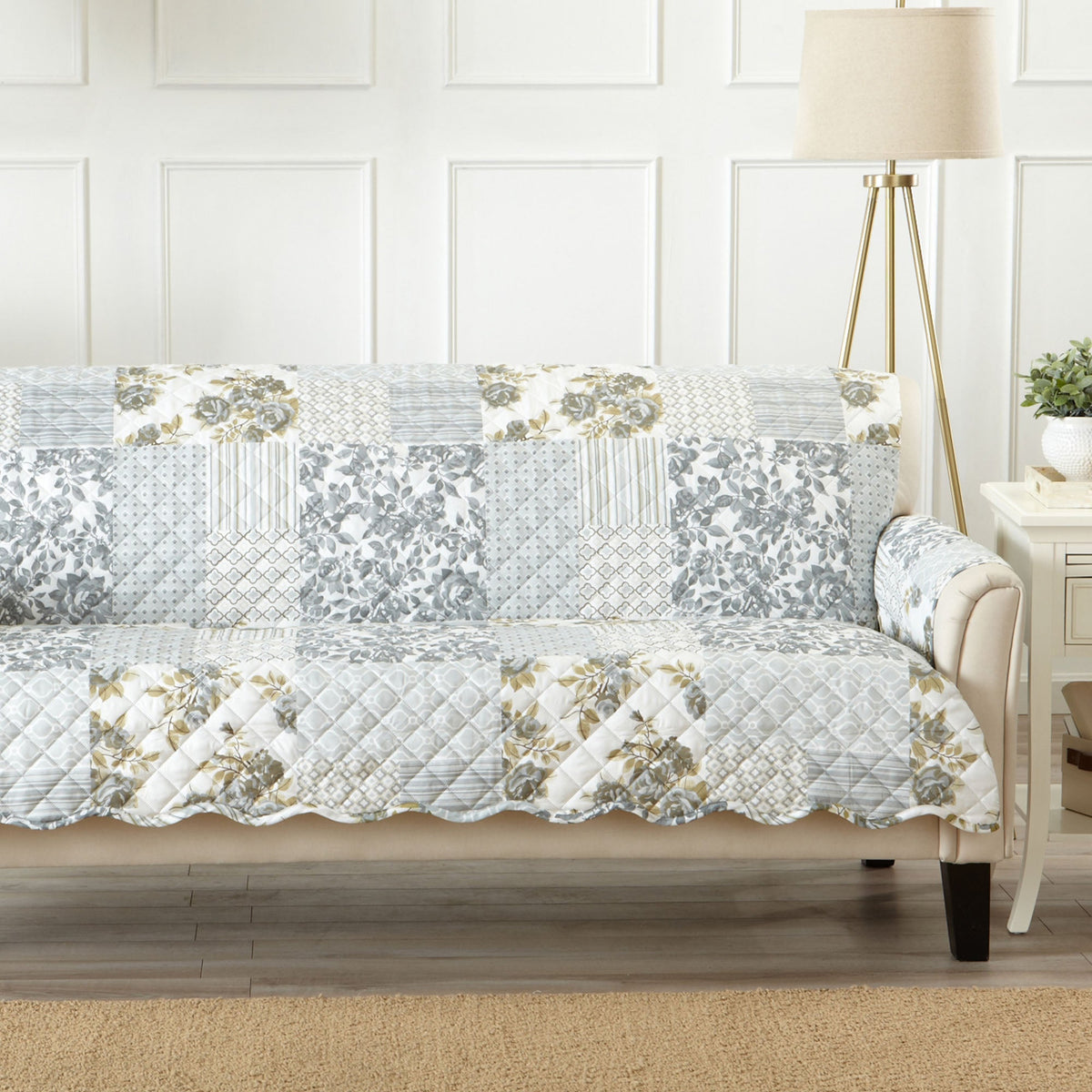 Reversible furniture protector on a sofa or chair with light gray patchwork and floral accents.