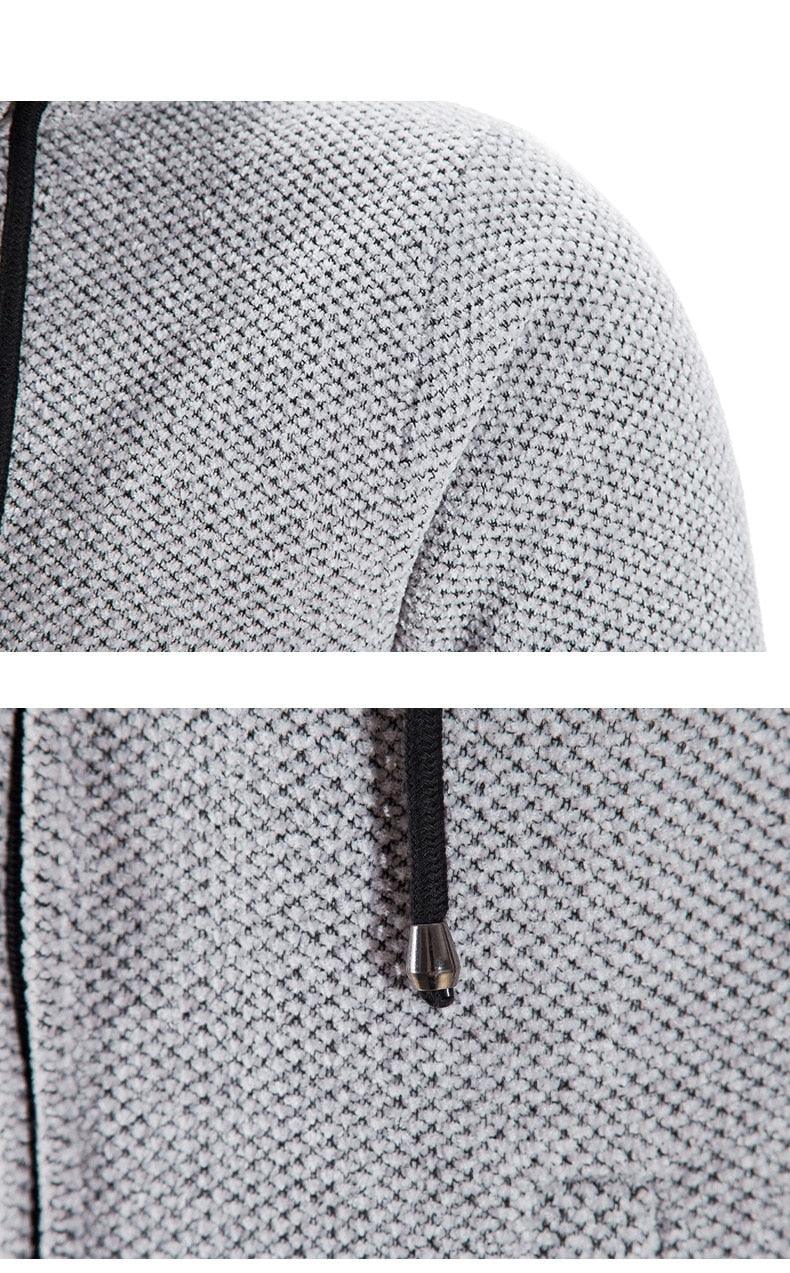 Light gray hooded jacket fabric close-up with black zipper and metal pull