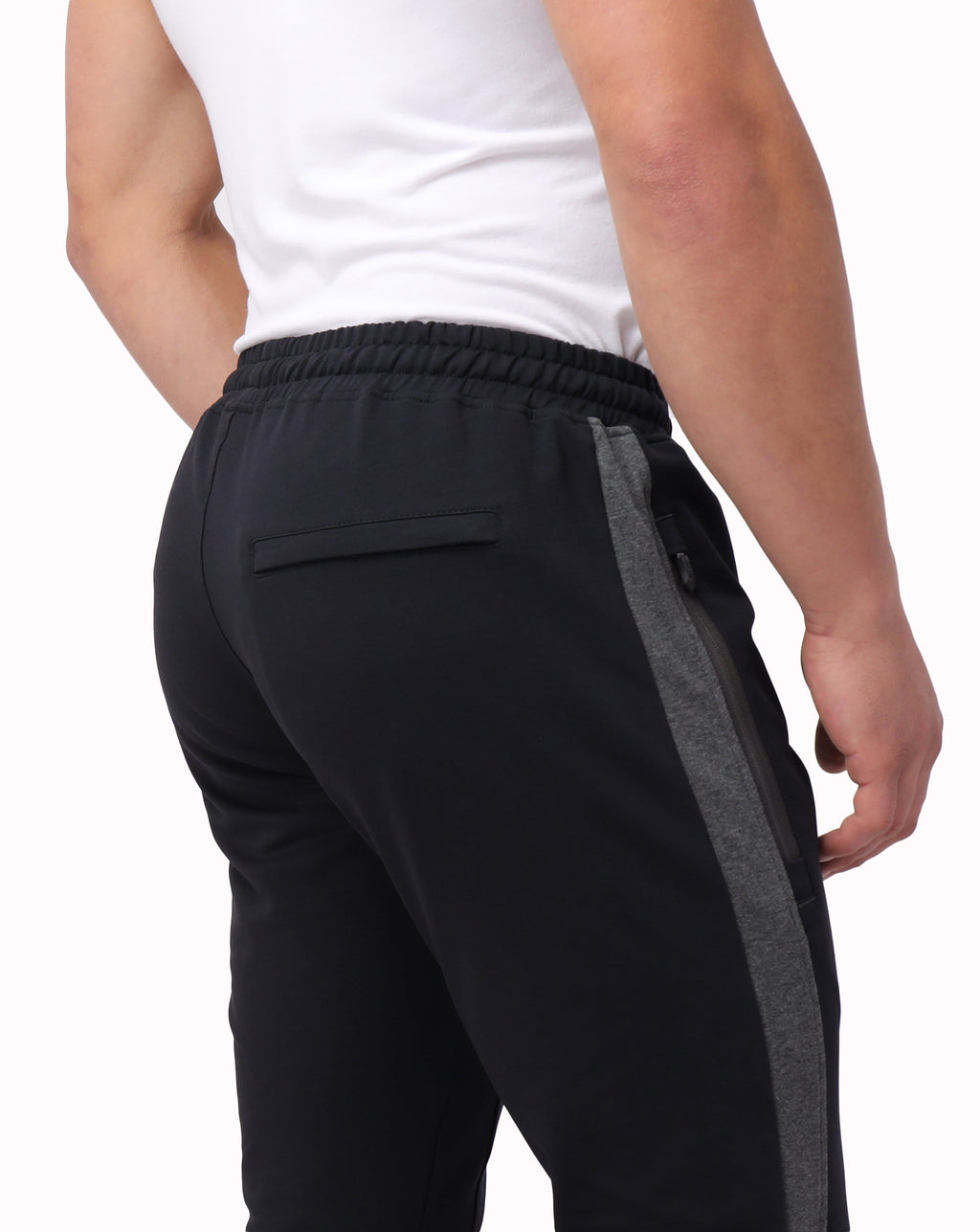 Tall fit jogger pants in dark black with side stripe and zip pocket detail.