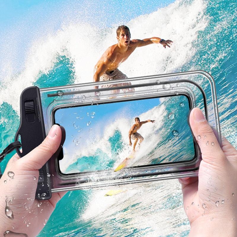 Hands holding transparent waterproof phone pouch while surfing waves