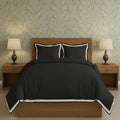 Black duvet cover set with white border frame and matching pillow shams