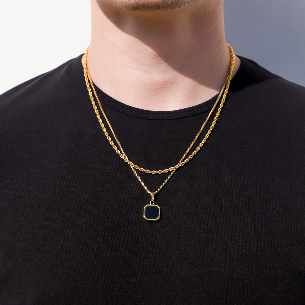 Gold-tone pendant necklace set with two chains and a square black onyx charm