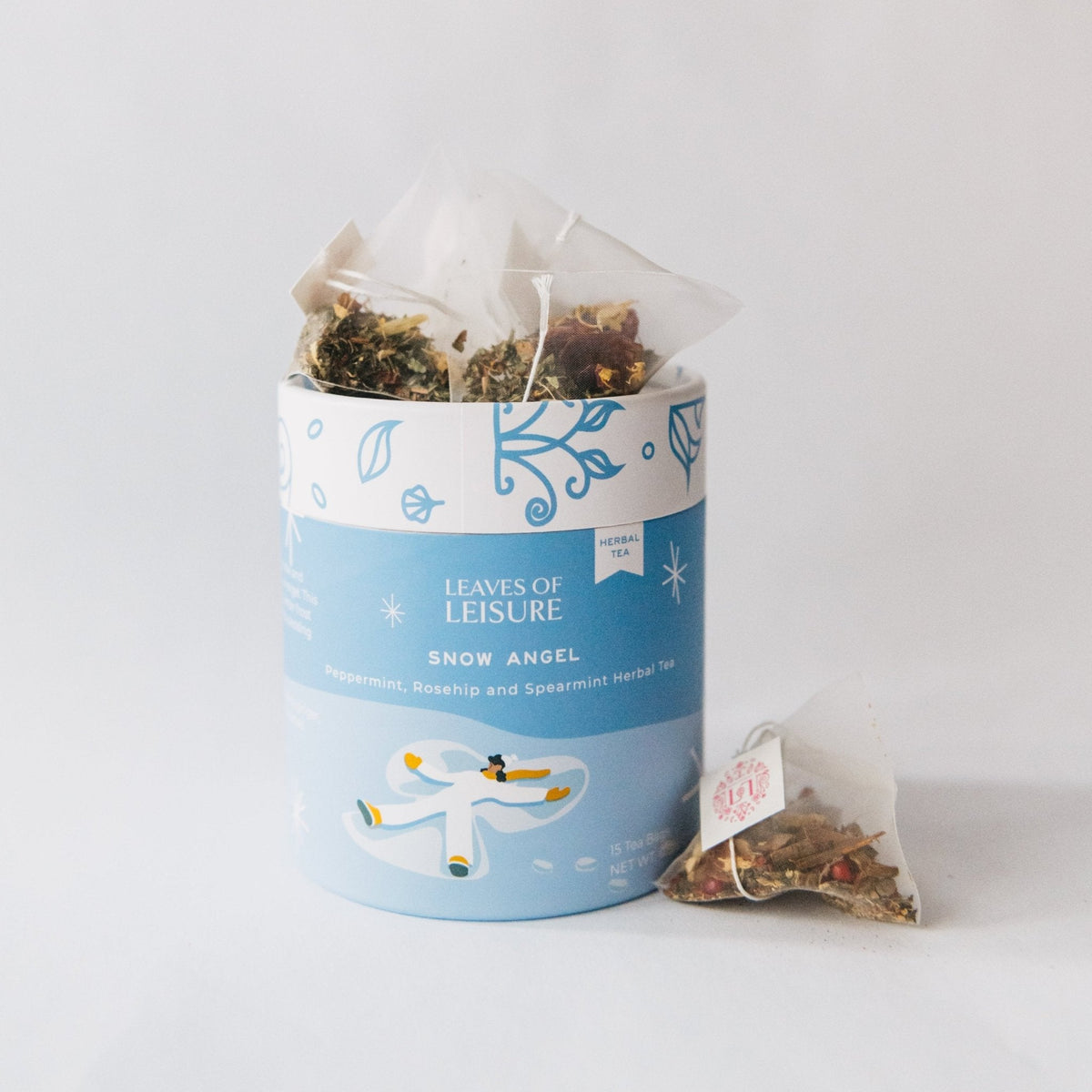 Blue herbal tea tin with bundled sachet of loose tea beside it