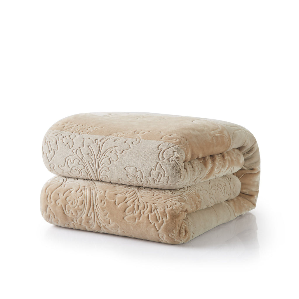 Stacked beige embossed sherpa throw blanket rolls with bubbly floral pattern