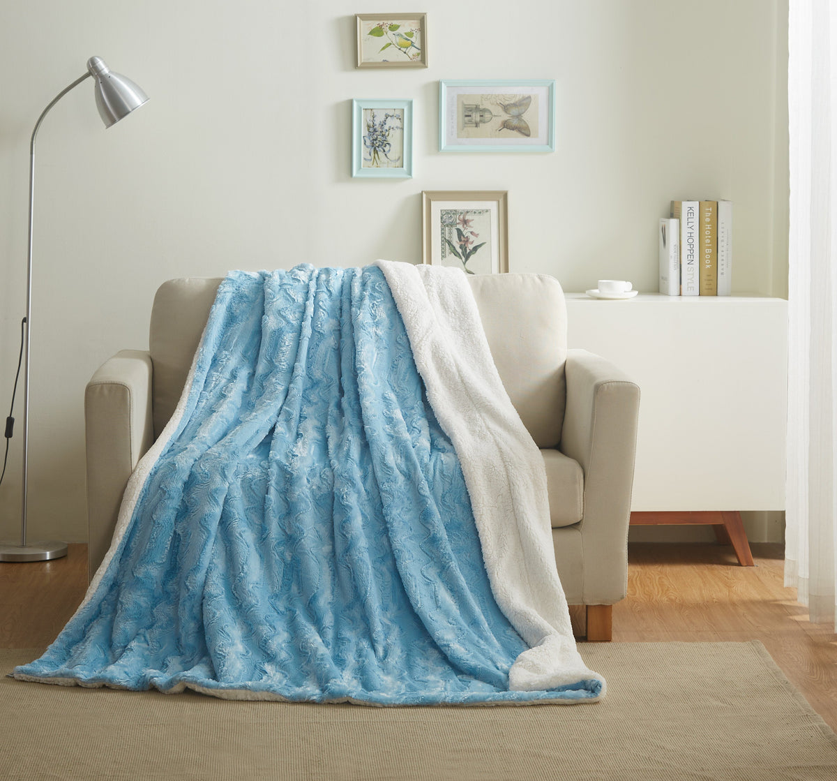 Blue faux fur throw blanket draped over couch, plush long pile
