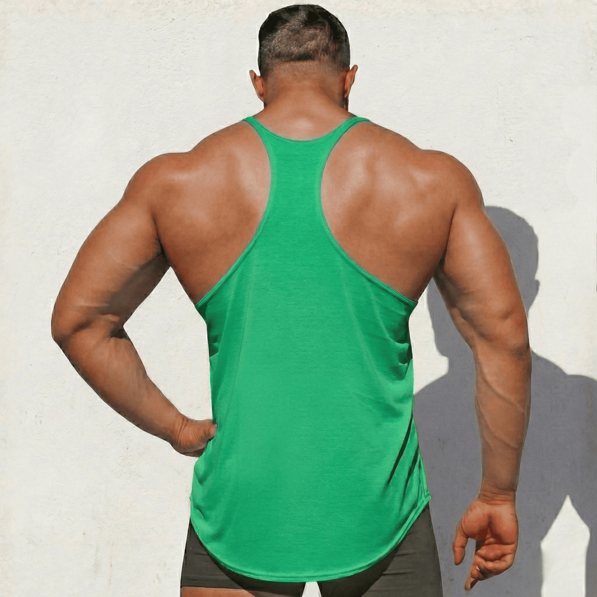Green stringer tank top viewed from back, wide racerback straps and hem