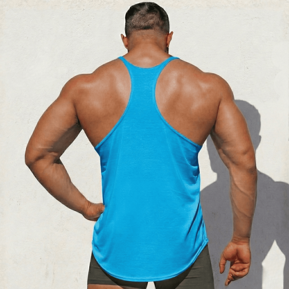 Bright blue stringer tank top from back, racerback cut and side hem