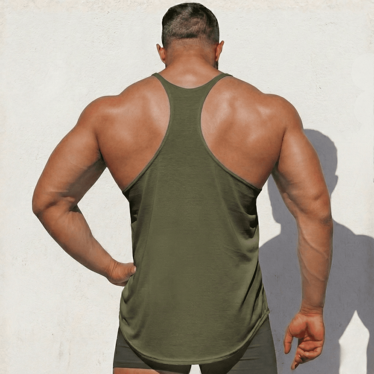 Army green stringer tank top, racerback back view with curved hem and side seams