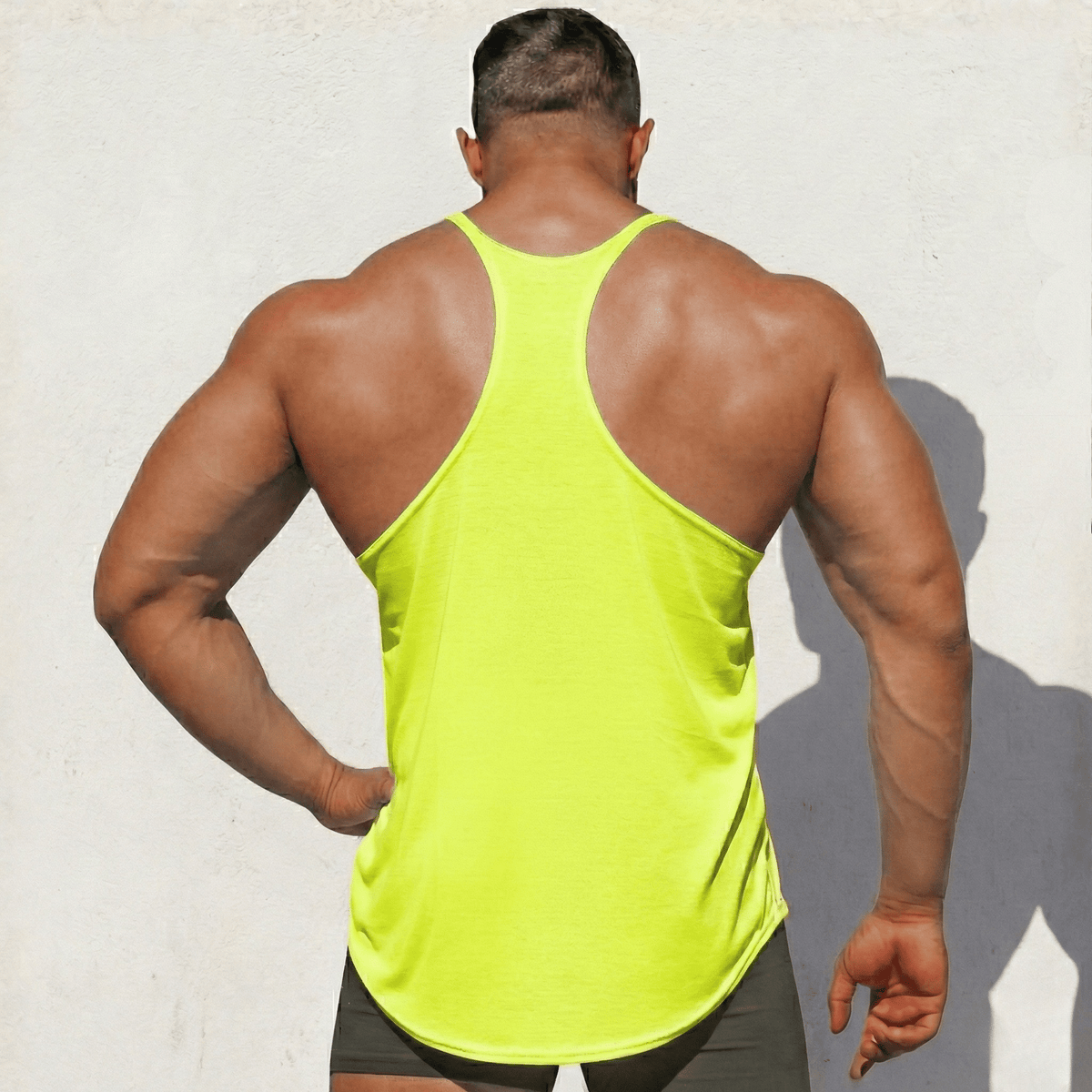 Neon yellow stringer tank top from back, racerback straps and side hem