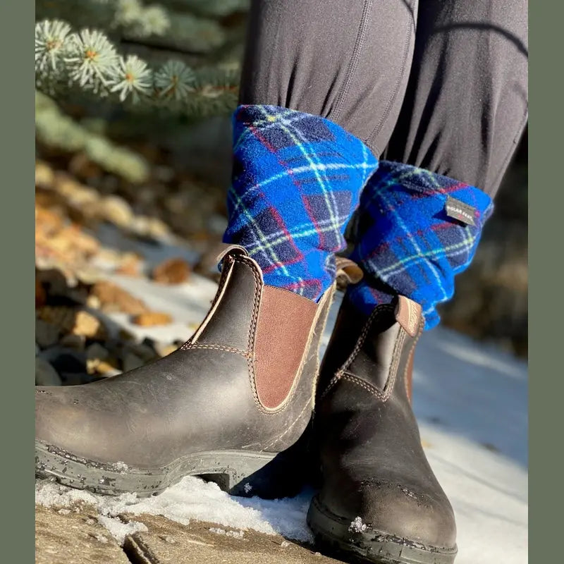 Blue argyle fleece socks under winter boots, showing patterned cuff.