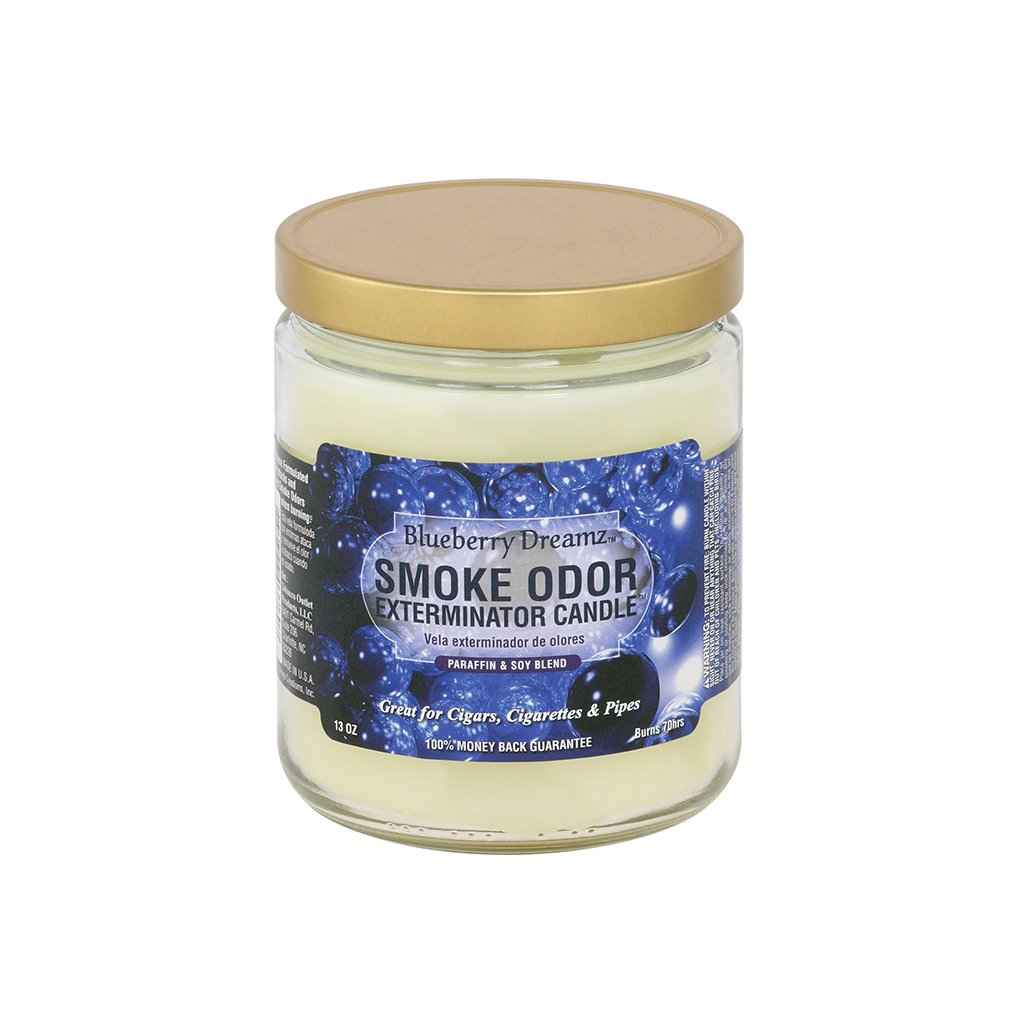Scented candle in clear glass jar with gold lid, blue label reading smoke odor exterminator